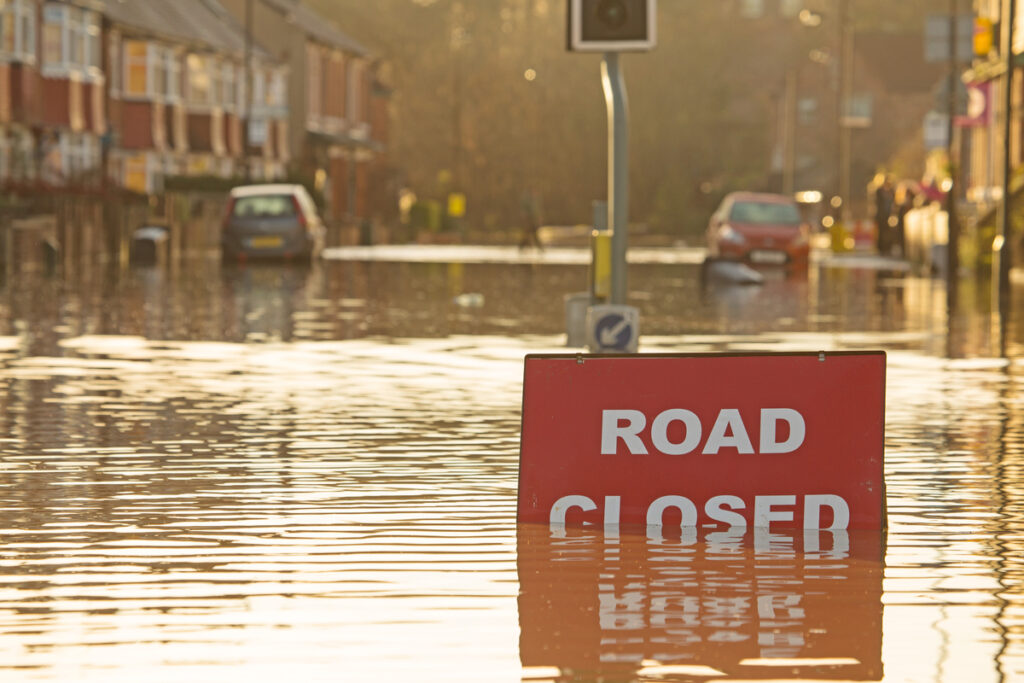 A “road closed” sign on a flooded street